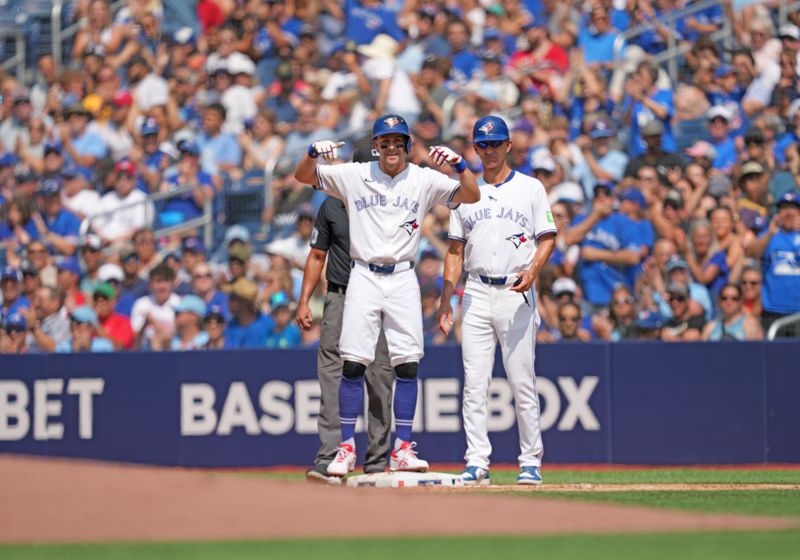 Jul 27, 2024; Toronto, Ontario, CAN; Toronto Blue Jays shortstop Ernie Clement (28) hits an RBI single against the Texas Rangers during the first inning at Rogers Centre. Mandatory Credit: Nick Turchiaro-USA TODAY Sports