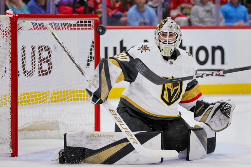 Dec 23, 2023; Sunrise, Florida, USA; Vegas Golden Knights goaltender Jiri Patera (30) watches the puck go wide against the Florida Panthers during the second period at Amerant Bank Arena. Mandatory Credit: Sam Navarro-USA TODAY Sports