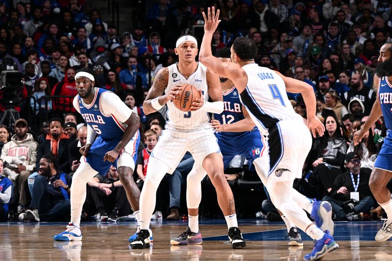 PHILADELPHIA, PA - FEBRUARY 1: Paolo Banchero #5 of the Orlando Magic handles the ball during the game against the Philadelphia 76ers on February 1, 2023 at the Wells Fargo Center in Philadelphia, Pennsylvania NOTE TO USER: User expressly acknowledges and agrees that, by downloading and/or using this Photograph, user is consenting to the terms and conditions of the Getty Images License Agreement. Mandatory Copyright Notice: Copyright 2023 NBAE (Photo by David Dow/NBAE via Getty Images)