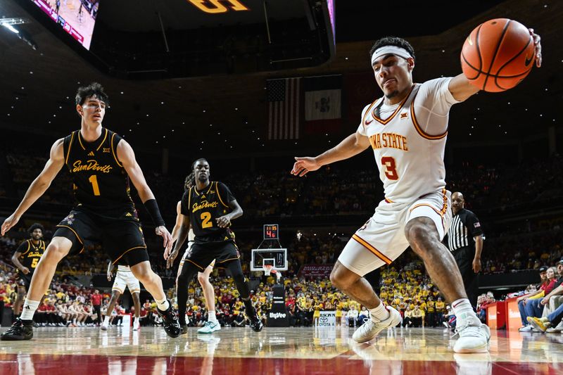 Mar 7, 2026; Ames, Iowa, USA;  Iowa State Cyclones guard Tamin Lipsey (3) grabs a loose ball as Arizona State Sun Devils forward Santiago Trouet (1) and guard Anthony Johnson (2) look on during the first half at James H. Hilton Coliseum. Mandatory Credit: Jeffrey Becker-Imagn Images