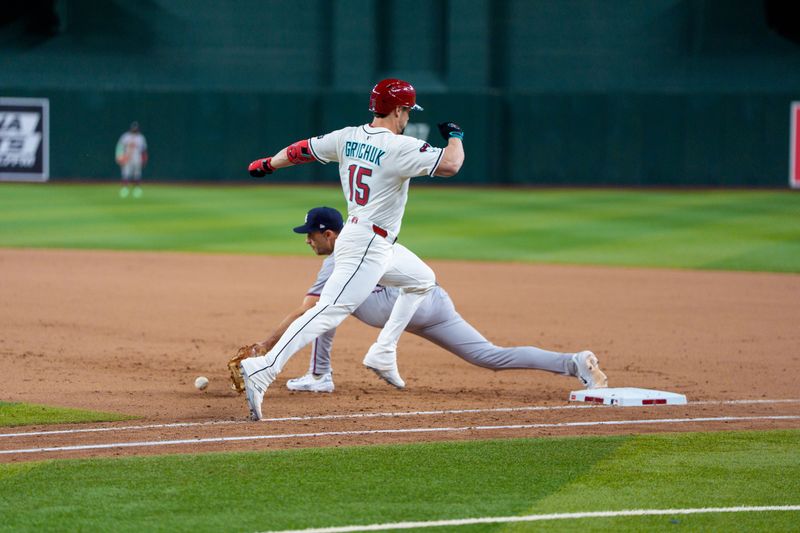 Apr 26, 2025; Phoenix, Arizona, USA;  Arizona Diamondbacks outfielder Randal Grichuk (15) can’t beat the throw to first as Atlanta Braves infielder Matt Olson (28) reaches out to make the out during the tenth inning at Chase Field. Mandatory Credit: Allan Henry-Imagn Images