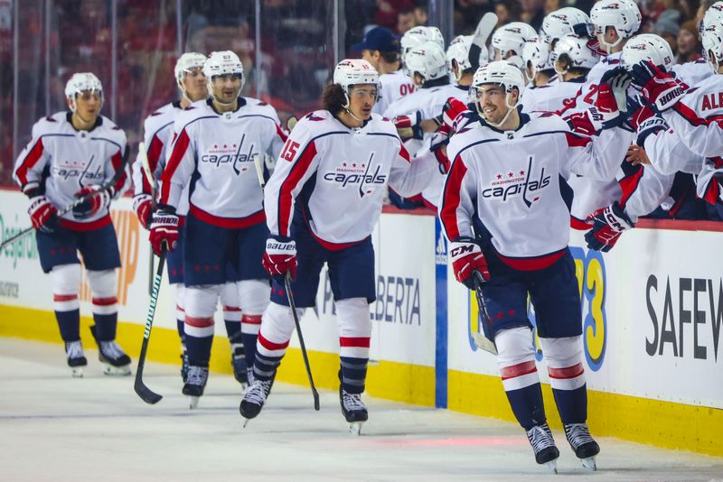 Mar 18, 2024; Calgary, Alberta, CAN; Washington Capitals center Hendrix Lapierre (29) celebrates his goal with teammates against the Calgary Flames during the second period at Scotiabank Saddledome. Mandatory Credit: Sergei Belski-USA TODAY Sports