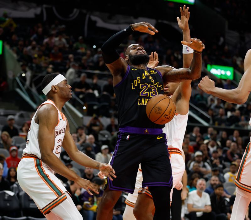 SAN ANTONIO, TX - DECEMBER 15: LeBron James #23 of the Los Angeles Lakers is fouled by Malaki Branham #22 of the San Antonio Spurs  in the first half at Frost Bank Center on December  15, 2023 in San Antonio, Texas. NOTE TO USER: User expressly acknowledges and agrees that, by downloading and or using this photograph, User is consenting to terms and conditions of the Getty Images License Agreement. (Photo by Ronald Cortes/Getty Images)