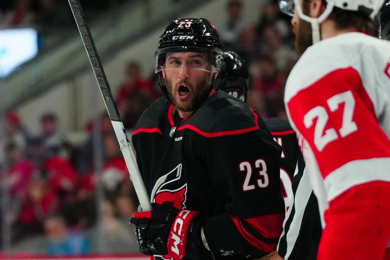 Jan 19, 2024; Raleigh, North Carolina, USA; Carolina Hurricanes right wing Stefan Noesen (23) reacts to Detroit Red Wings center Michael Rasmussen (27) during the third period at PNC Arena. Mandatory Credit: James Guillory-USA TODAY Sports