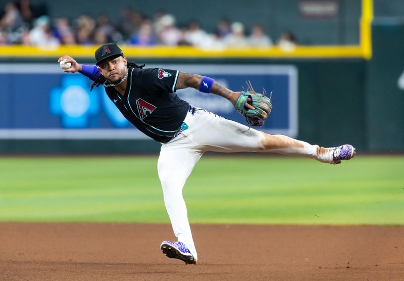 May 5, 2025; Phoenix, Arizona, USA; Arizona Diamondbacks second baseman Ketel Marte fields an infield hit in the seventh inning against the New York Mets at Chase Field. Mandatory Credit: Mark J. Rebilas-Imagn Images