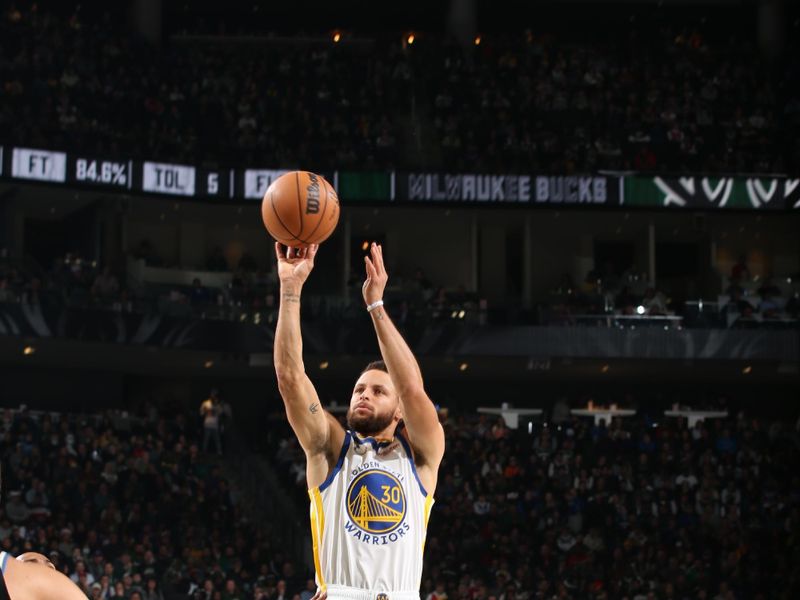 MILWAUKEE, WI - DECEMBER 13: Stephen Curry #30 of the Golden State Warriors shoots the ball during the game against the Milwaukee Bucks on December 13, 2022 at the Fiserv Forum Center in Milwaukee, Wisconsin. NOTE TO USER: User expressly acknowledges and agrees that, by downloading and or using this Photograph, user is consenting to the terms and conditions of the Getty Images License Agreement. Mandatory Copyright Notice: Copyright 2022 NBAE (Photo by Gary Dineen/NBAE via Getty Images).