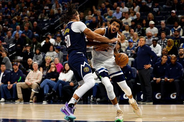 MINNEAPOLIS, MINNESOTA - NOVEMBER 01: Karl-Anthony Towns #32 of the Minnesota Timberwolves drives to the basket while Aaron Gordon #50 of the Denver Nuggets defends in the second quarter at Target Center on November 01, 2023 in Minneapolis, Minnesota. The Timberwolves defeated the Nuggets 110-89. NOTE TO USER: User expressly acknowledges and agrees that, by downloading and or using this photograph, User is consenting to the terms and conditions of the Getty Images License Agreement. (Photo by David Berding/Getty Images)