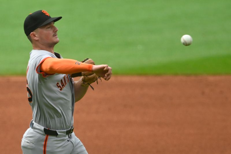 Jul 6, 2024; Cleveland, Ohio, USA; San Francisco Giants third baseman Matt Chapman (26) throws to first base in the first inning against the Cleveland Guardians at Progressive Field. Mandatory Credit: David Richard-USA TODAY Sports