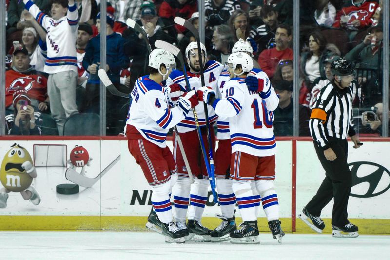 Feb 22, 2024; Newark, New Jersey, USA; New York Rangers left wing Chris Kreider (20) celebrates with teammates after scoring a goal against the New Jersey Devils during the second period at Prudential Center. Mandatory Credit: John Jones-USA TODAY Sports