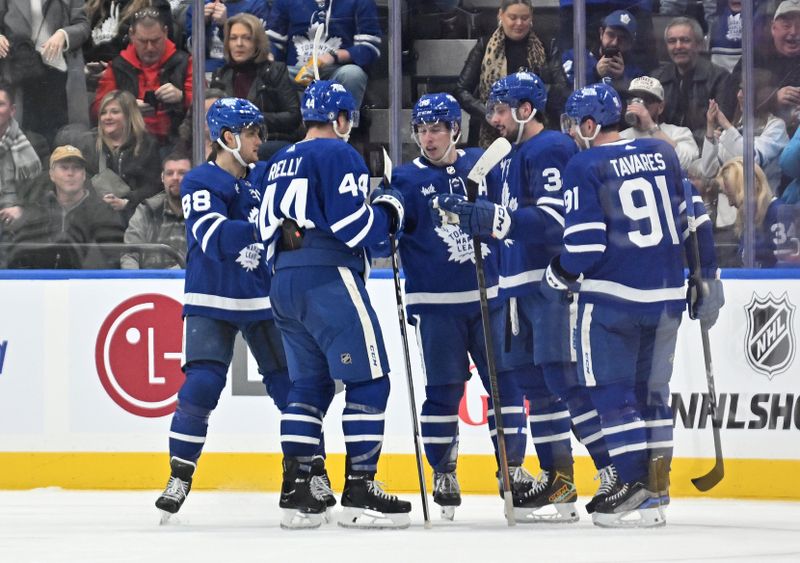 Feb 7, 2024; Toronto, Ontario, CAN; Toronto Maple Leafs forward Auston Matthews (34) celebrates with team mates after scoring a goal against the Dallas Stars in the second period at Scotiabank Arena. Mandatory Credit: Dan Hamilton-USA TODAY Sports