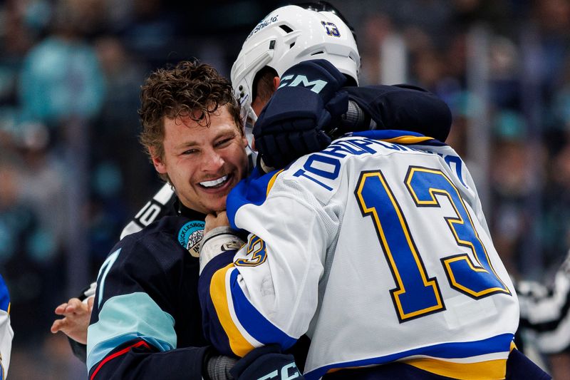 Oct 8, 2024; Seattle, Washington, USA; Seattle Kraken center Yanni Gourde (37) and St. Louis Blues right wing Alexey Toropchenko (13) scuffle during the second period at Climate Pledge Arena. Mandatory Credit: Caean Couto-Imagn Images