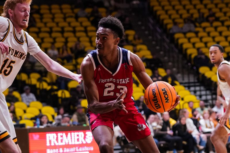 Jan 31, 2023; Laramie, Wyoming, USA; Fresno State Bulldogs guard Leo Colimerio (23) drives against Wyoming Cowboys forward Nate Barnhart (15) during the second half at Arena-Auditorium. Mandatory Credit: Troy Babbitt-USA TODAY Sports