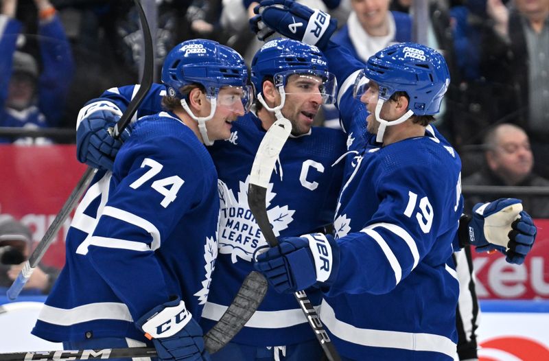 Mar 2, 2024; Toronto, Ontario, CAN;  Toronto Maple Leafs forward John Tavares (91) celebrates with forwards Bobby McMann (74) and Calle Jarnkrok (19) after scoring against the New York Rangers in the third period at Scotiabank Arena. Mandatory Credit: Dan Hamilton-USA TODAY Sports