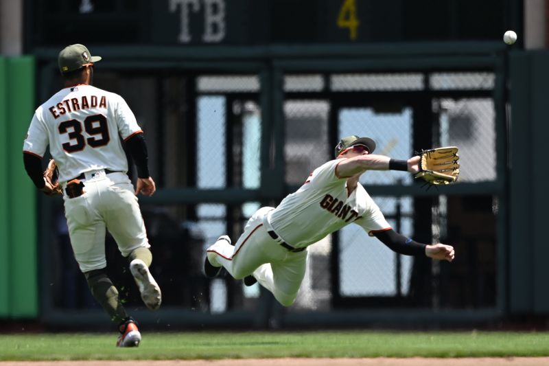 May 21, 2023; San Francisco, California, USA; San Francisco Giants outfielder Mike Yastrzemski (5) makes a  catch of a fly ball against the Miami Marlins during the fourth inning at Oracle Park. Mandatory Credit: Robert Edwards-USA TODAY Sports