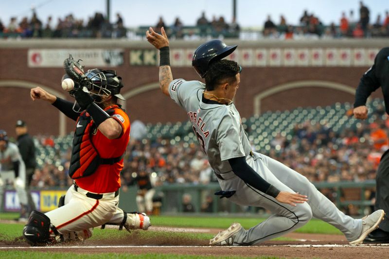 Aug 9, 2024; San Francisco, California, USA; Detroit Tigers third baseman Gio Urshela (13) slides safely home on a sacrifice fly as the throw gets by San Francisco Giants catcher Curt Casali (2) during the second inning at Oracle Park. Mandatory Credit: D. Ross Cameron-USA TODAY Sports