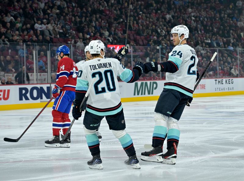 Oct 29, 2024; Montreal, Quebec, CAN; Seattle Kraken defenseman Jamie Oleksiak (24) celebrates with forward Eeli Tolvanen (20) after scoring a goal against the Montreal Canadiens during the first period at the Bell Centre. Mandatory Credit: Eric Bolte-Imagn Images