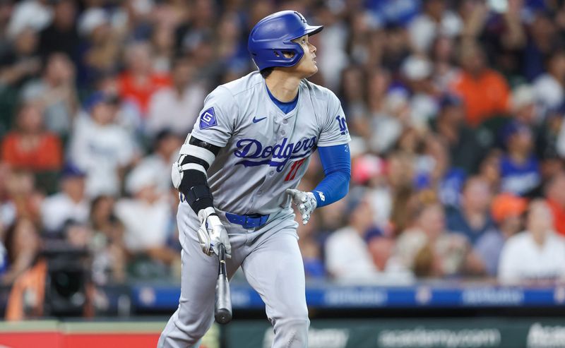 Jul 27, 2024; Houston, Texas, USA; Los Angeles Dodgers designated hitter Shohei Ohtani (17) hits a fly ball during the first inning against the Houston Astros at Minute Maid Park. Mandatory Credit: Troy Taormina-USA TODAY Sports