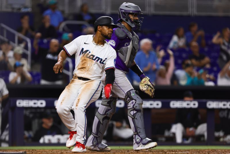 May 1, 2024; Miami, Florida, USA; Miami Marlins third baseman Otto Lopez (61) scores against the Colorado Rockies during the eighth inning at loanDepot Park. Mandatory Credit: Sam Navarro-USA TODAY Sports