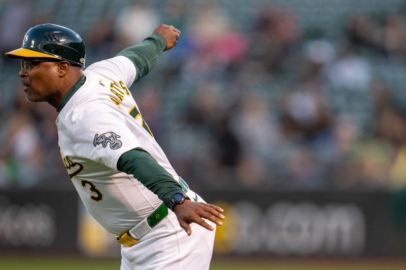 Aug 5, 2024; Oakland, California, USA;  Oakland Athletics third base coach Eric Martins (3) wavies Oakland Athletics second baseman Zack Gelof (not pictured)  against the Chicago White Sox during the fourth inning at Oakland-Alameda County Coliseum. Mandatory Credit: Neville E. Guard-USA TODAY Sports