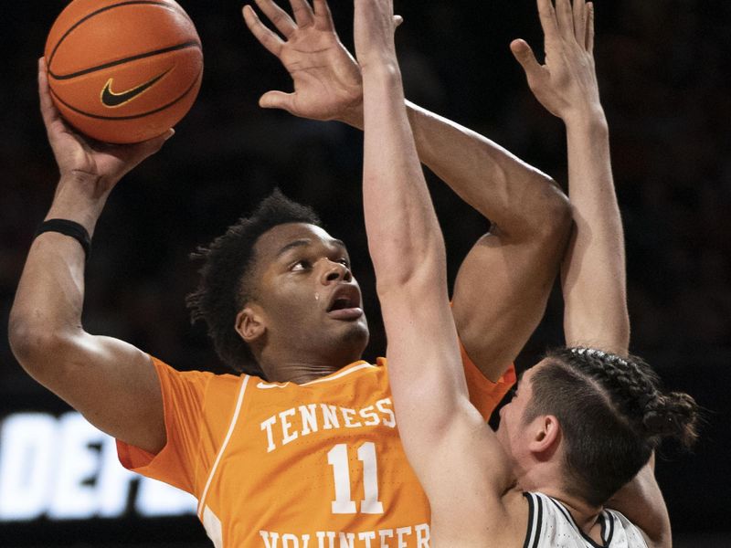 Feb 8, 2023; Nashville, Tennessee, USA;  Tennessee Volunteers forward Tobe Awaka (11) shoots over Vanderbilt Commodores forward Quentin Millora-Brown (42) during the second half at Memorial Gymnasium. Vanderbilt defeated Tennessee 66 to 65.  Mandatory Credit: George Walker IV - USA TODAY Sports