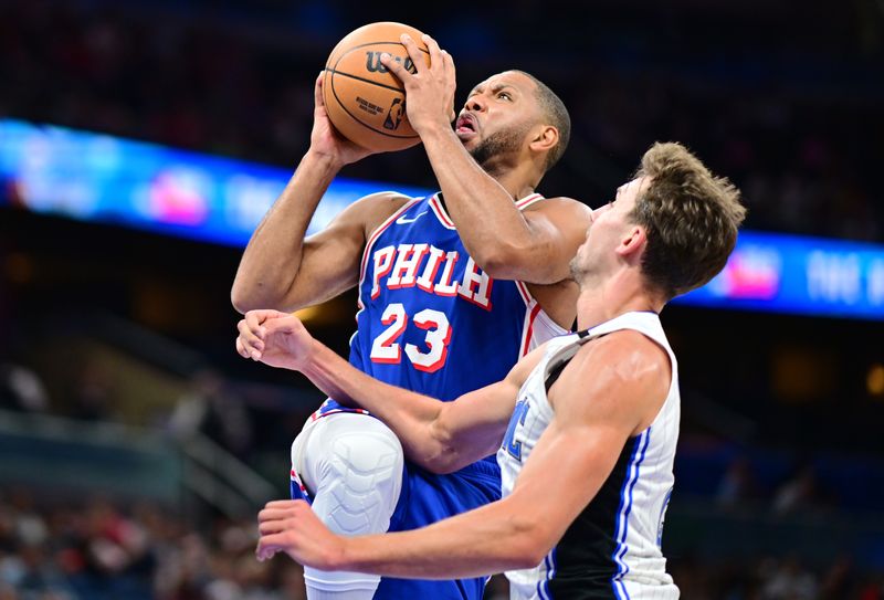 ORLANDO, FLORIDA - OCTOBER 18: Eric Gordon #23 of the Philadelphia 76ers drives to the net against Franz Wagner #22 of the Orlando Magic in the first half of a game at Kia Center on October 18, 2024 in Orlando, Florida. NOTE TO USER: User expressly acknowledges and agrees that, by downloading and or using this photograph, User is consenting to the terms and conditions of the Getty Images License Agreement. (Photo by Julio Aguilar/Getty Images)