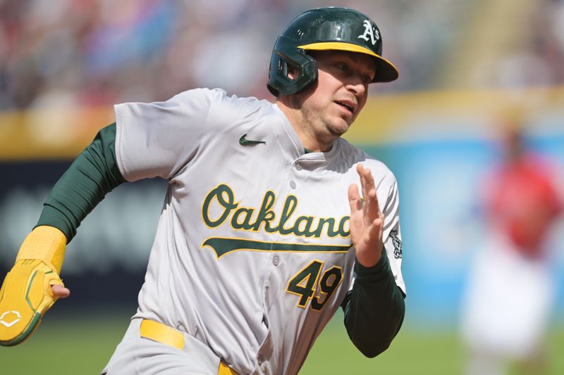 Apr 21, 2024; Cleveland, Ohio, USA; Oakland Athletics first baseman Ryan Noda (49) rounds third base en route to scoring during the sixth inning against the Cleveland Guardians at Progressive Field. Mandatory Credit: Ken Blaze-USA TODAY Sports