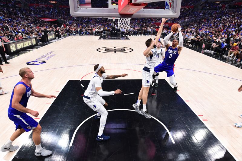 LOS ANGELES, CA - APRIL 21:  Russell Westbrook #0 of the LA Clippers drives to the basket during the game against the Dallas Mavericks during Round 1 Game 1 of the 2024 NBA Playoffs on April 21, 2024 at Crypto.Com Arena in Los Angeles, California. NOTE TO USER: User expressly acknowledges and agrees that, by downloading and/or using this Photograph, user is consenting to the terms and conditions of the Getty Images License Agreement. Mandatory Copyright Notice: Copyright 2024 NBAE (Photo by Adam Pantozzi/NBAE via Getty Images)