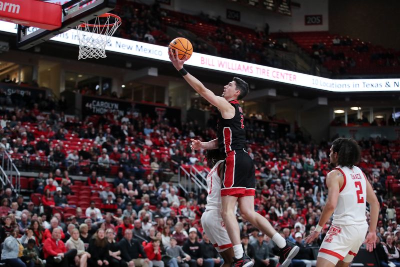 Dec 13, 2022; Lubbock, Texas, USA; Eastern Washington Eagles forward Steele Venters (2) goes to the basket against Texas Tech Red Raiders guard Lamar Washington (1) in the second half at United Supermarkets Arena. Mandatory Credit: Michael C. Johnson-USA TODAY Sports