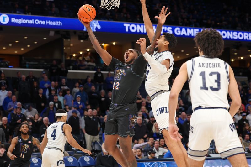 Feb 26, 2025; Memphis, Tennessee, USA; Memphis Tigers forward Dain Dainja (42) shoots against Rice Owls forward Jimmy Oladokun, Jr. (24) during the first half at FedExForum. Mandatory Credit: Wesley Hale-Imagn Images