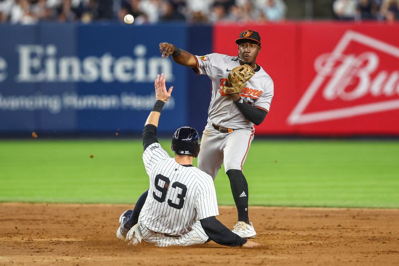 Jun 19, 2024; Bronx, New York, USA;  Baltimore Orioles second baseman Jorge Mateo (3) throws past New York Yankees first baseman Ben Rice (93) to complete a double play in the eighth inning at Yankee Stadium. Mandatory Credit: Wendell Cruz-USA TODAY Sports