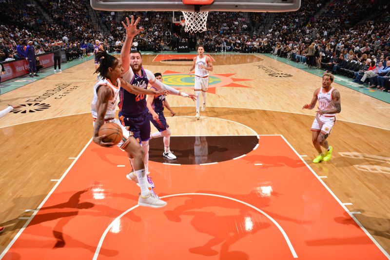 SAN ANTONIO, TX - MARCH 25: Devin Vassell #24 of the San Antonio Spurs looks to pass the ball during the game against the Phoenix Suns on March 25, 2024 at the AT&T Center in San Antonio, Texas. NOTE TO USER: User expressly acknowledges and agrees that, by downloading and or using this photograph, user is consenting to the terms and conditions of the Getty Images License Agreement. Mandatory Copyright Notice: Copyright 2024 NBAE (Photos by Jesse D. Garrabrant/NBAE via Getty Images)