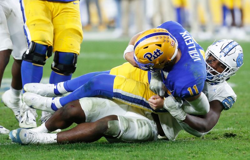 Sep 23, 2023; Pittsburgh, Pennsylvania, USA; North Carolina Tar Heels linebacker Kaimon Rucker (25) sacks Pittsburgh Panthers quarterback Christian Veilleux (11) during the fourth quarter at Acrisure Stadium. The Tar Heels won 41-24. Mandatory Credit: Charles LeClaire-USA TODAY Sports