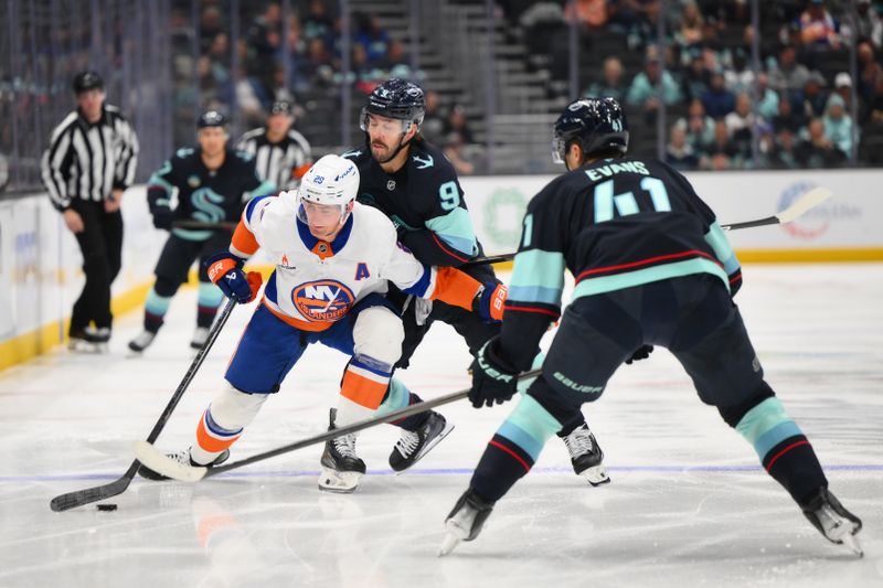 Nov 16, 2024; Seattle, Washington, USA; New York Islanders center Brock Nelson (29) plays the puck while defended by Seattle Kraken center Chandler Stephenson (9) during the second period at Climate Pledge Arena. Mandatory Credit: Steven Bisig-Imagn Images