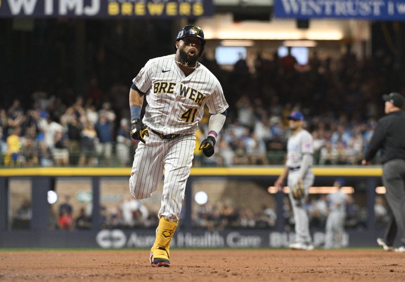 Sep 30, 2023; Milwaukee, Wisconsin, USA; Milwaukee Brewers first baseman Carlos Santana (41) celebrates hitting a home run against the Chicago Cubs in the second inning at American Family Field. Mandatory Credit: Michael McLoone-USA TODAY Sports