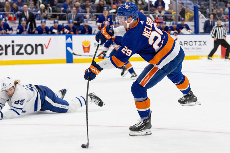 Dec 11, 2023; Elmont, New York, USA; New York Islanders center Brock Nelson (29) takes a shot against the Toronto Maple Leafs during the second period at UBS Arena. Mandatory Credit: Thomas Salus-USA TODAY Sports