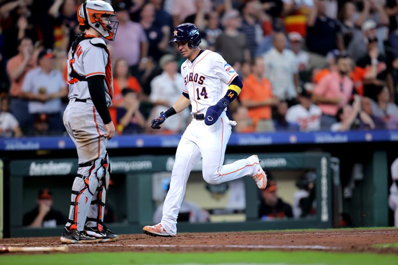 Sep 20, 2023; Houston, Texas, USA; Houston Astros pinch hitter Mauricio Dubon (14) crosses home plate to score a run against the Baltimore Orioles during the eighth inning at Minute Maid Park. Mandatory Credit: Erik Williams-USA TODAY Sports