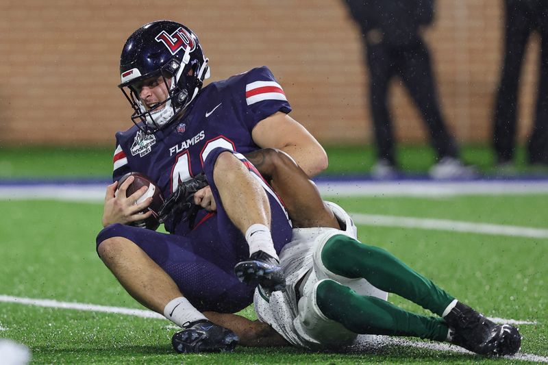 Dec 18, 2021; Mobile, Alabama, USA; Liberty Flames tight end BJ Wheat Jr. (40) is tackled by Eastern Michigan Eagles defensive back T.J. Peavy (8) on a two point attempt in the third quarter during the 2021 LendingTree Bowl at Hancock Whitney Stadium. Mandatory Credit: Robert McDuffie-USA TODAY Sports