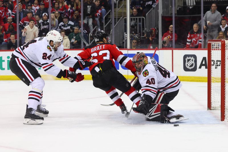 Jan 5, 2024; Newark, New Jersey, USA; Chicago Blackhawks goaltender Arvid Soderblom (40) makes a save on New Jersey Devils left wing Jesper Bratt (63) during the second period at Prudential Center. Mandatory Credit: Ed Mulholland-USA TODAY Sports