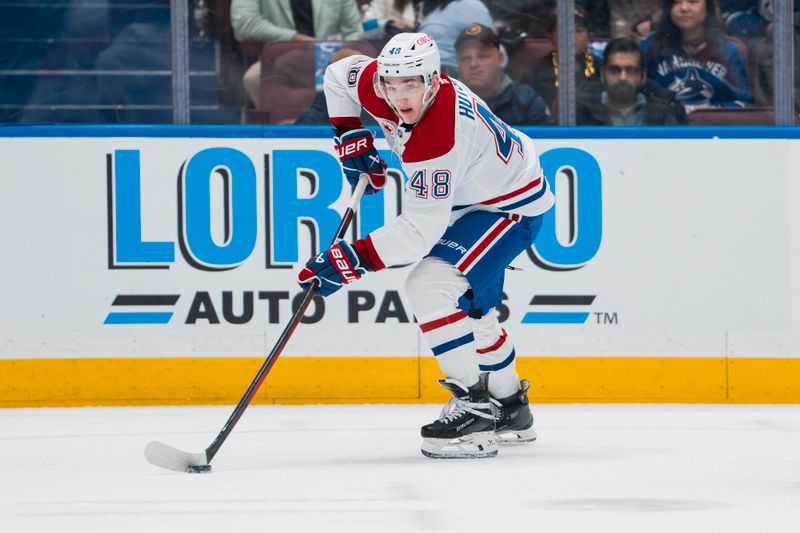 Mar 11, 2025; Vancouver, British Columbia, CAN; Montreal Canadiens defenseman Lane Hutson (48) handles the puck against the Vancouver Canucks in the first period at Rogers Arena. Mandatory Credit: Bob Frid-Imagn Images