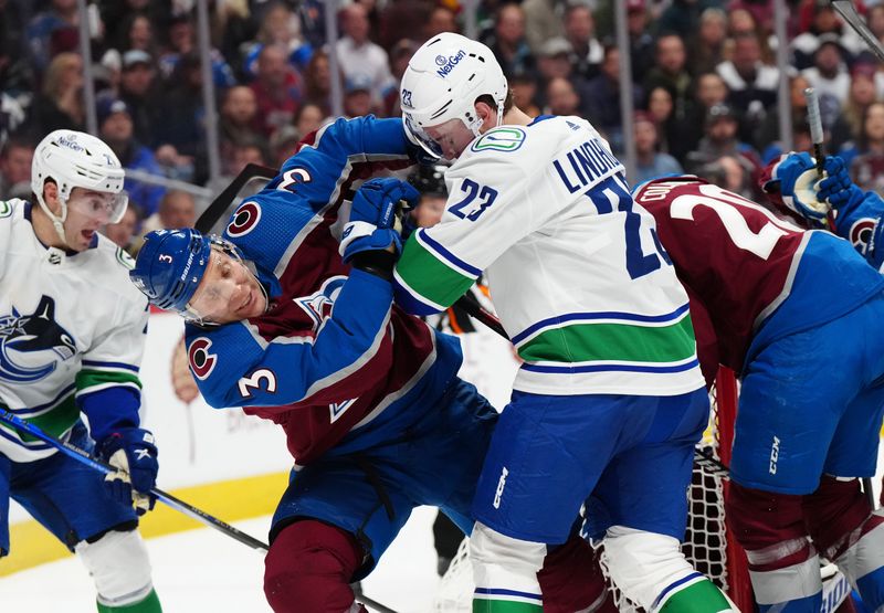 Feb 20, 2024; Denver, Colorado, USA; Vancouver Canucks center Elias Lindholm (23) pushes Colorado Avalanche defenseman Jack Johnson (3) in the third period at Ball Arena. Mandatory Credit: Ron Chenoy-USA TODAY Sports