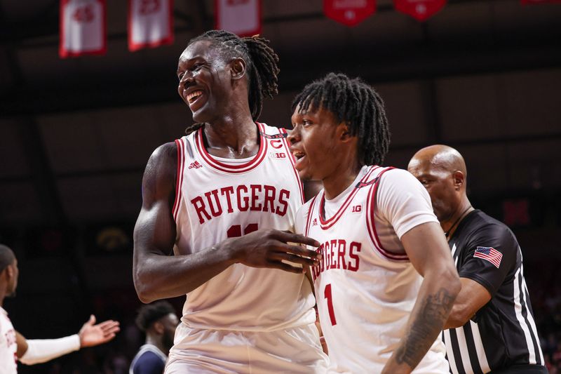 Nov 15, 2023; Piscataway, New Jersey, USA; Rutgers Scarlet Knights center Clifford Omoruyi (11) reacts with guard Jamichael Davis (1) after being fouled during the second half against the Georgetown Hoyas at Jersey Mike's Arena. Mandatory Credit: Vincent Carchietta-USA TODAY Sports