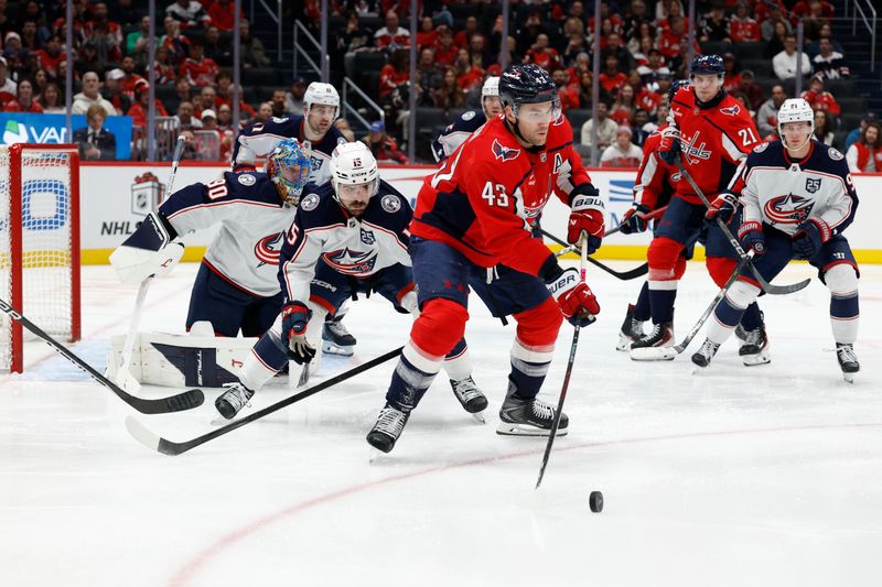 Nov 24, 2025; Washington, District of Columbia, USA; Washington Capitals right wing Tom Wilson (43) passes the puck against in front of Columbus Blue Jackets goaltender Elvis Merzlikins (90) as Blue Jackets defenseman Dante Fabbro (15) defends during the third period at Capital One Arena. Mandatory Credit: Geoff Burke-Imagn Images