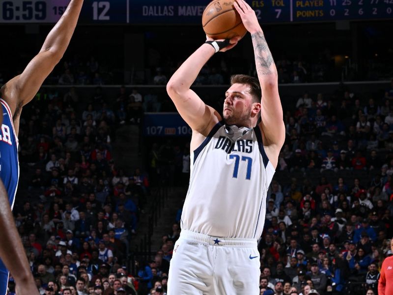 PHILADELPHIA, PA - MARCH 29: Luka Doncic #77 of the Dallas Mavericks shoots a three point basket during the game against the Philadelphia 76ers on March 29, 2023 at the Wells Fargo Center in Philadelphia, Pennsylvania NOTE TO USER: User expressly acknowledges and agrees that, by downloading and/or using this Photograph, user is consenting to the terms and conditions of the Getty Images License Agreement. Mandatory Copyright Notice: Copyright 2023 NBAE (Photo by David Dow/NBAE via Getty Images)