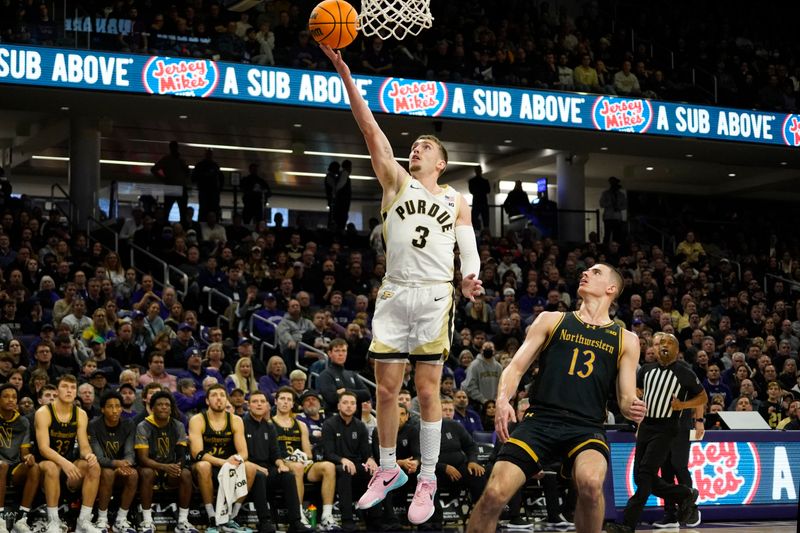 Dec 1, 2023; Evanston, Illinois, USA; Purdue Boilermakers guard Braden Smith (3) scores on Northwestern Wildcats guard Brooks Barnhizer (13) during the first half at Welsh-Ryan Arena. Mandatory Credit: David Banks-USA TODAY Sports