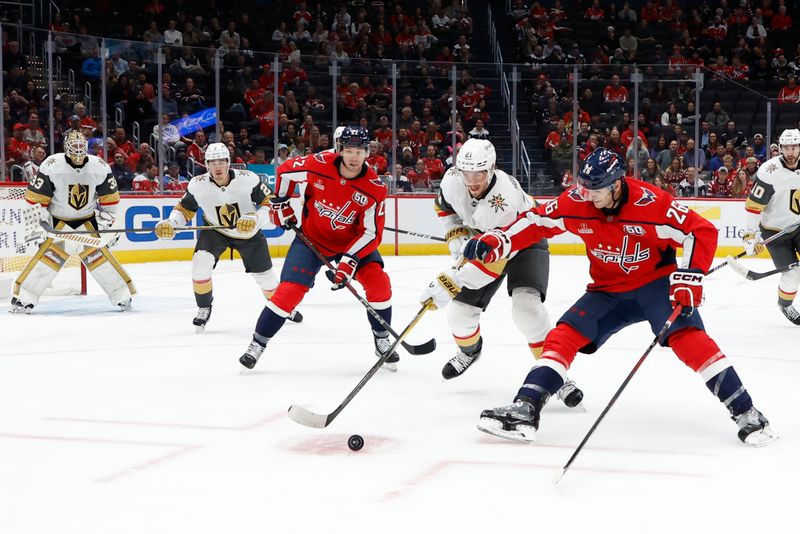 Oct 15, 2024; Washington, District of Columbia, USA; Vegas Golden Knights center Brett Howden (21) and Washington Capitals center Nic Dowd (26) battle for the puck in the first period at Capital One Arena. Mandatory Credit: Geoff Burke-Imagn Images