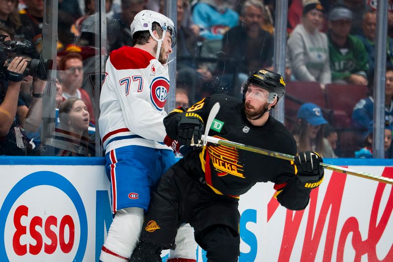 Oct 25, 2025; Vancouver, British Columbia, CAN; Vancouver Canucks defenseman Marcus Pettersson (29) checks Montreal Canadiens forward Kirby Dach (77) in the first period at Rogers Arena. Mandatory Credit: Bob Frid-Imagn Images