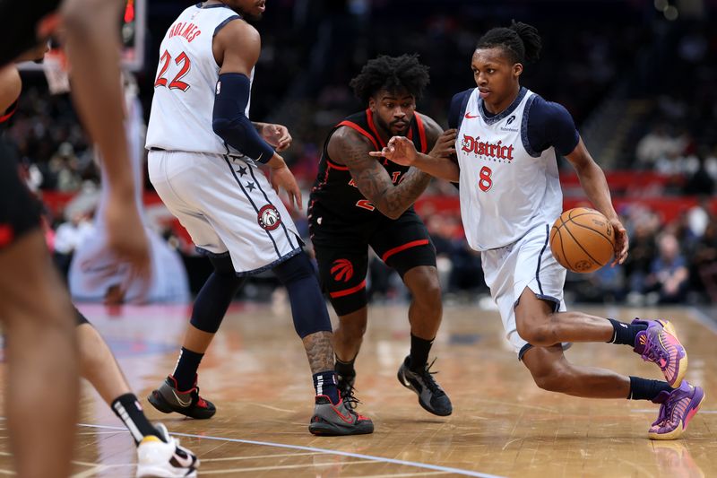 WASHINGTON, DC - JANUARY 29: Bub Carrington #8 of the Washington Wizards dribbles past Jamal Shead #23 of the Toronto Raptors during the second half at Capital One Arena on January 29, 2025 in Washington, DC. NOTE TO USER: User expressly acknowledges and agrees that, by downloading and or using this photograph, User is consenting to the terms and conditions of the Getty Images License Agreement. (Photo by Patrick Smith/Getty Images)