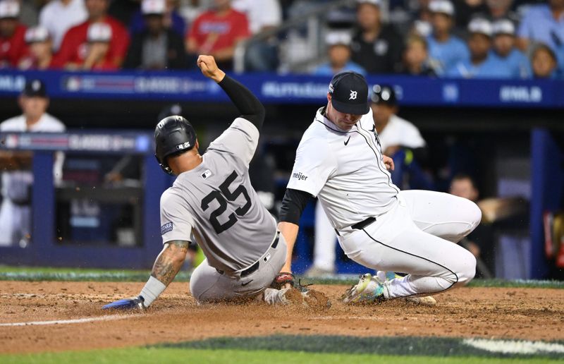 Aug 18, 2024; Williamsport, Pennsylvania, USA; New York Yankees infielder Gleyber Torres (25) slides home to score against Detroit Tigers starting pitcher Tarik Skubal (29) in the sixth inning at BB&T Ballpark at Historic Bowman Field. Mandatory Credit: Kyle Ross-USA TODAY Sports