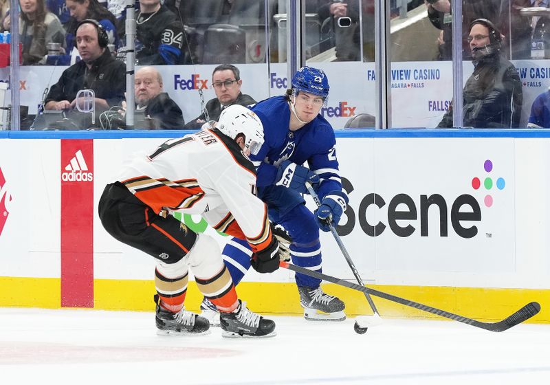 Feb 17, 2024; Toronto, Ontario, CAN; Toronto Maple Leafs left wing Matthew Knies (23) battles for the puck with Anaheim Ducks defenceman Cam Fowler (4) during the third period at Scotiabank Arena. Mandatory Credit: Nick Turchiaro-USA TODAY Sports