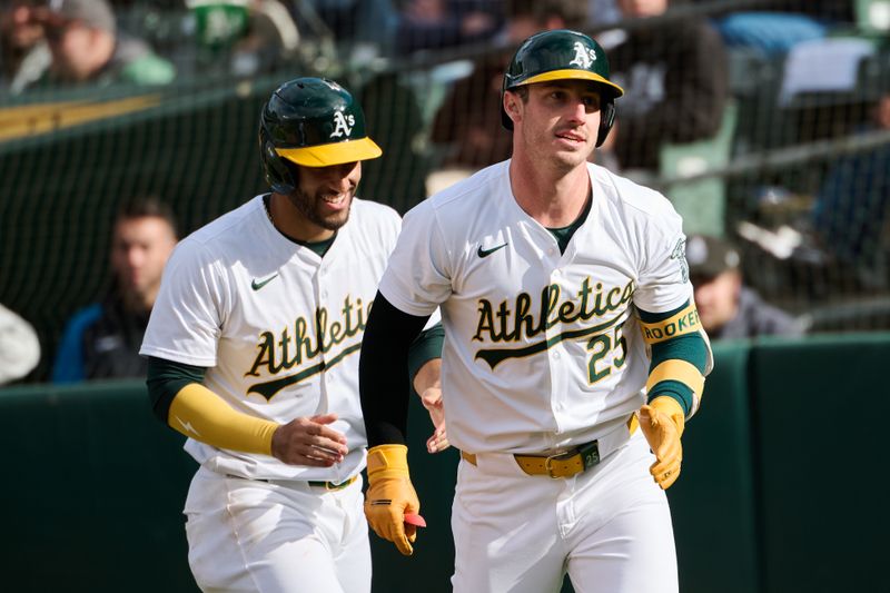 May 4, 2024; Oakland, California, USA; Oakland Athletics designated hitter Brent Rooker (25) returns to the dugout with infielder Abraham Toro (31) after hitting his second home run of the third inning against the Miami Marlins at Oakland-Alameda County Coliseum. Mandatory Credit: Robert Edwards-USA TODAY Sports